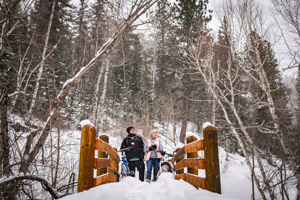 Couple standing on bridge in Spearfish Canyon in winter 