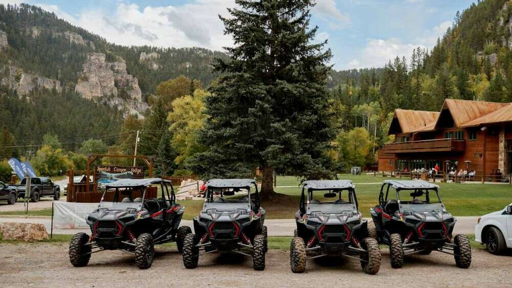 Fleet of Polaris RZRs in front of Spearfish Canyon Lodge