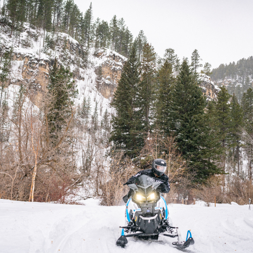 Snowmobile on trail in Spearfish Canyon 