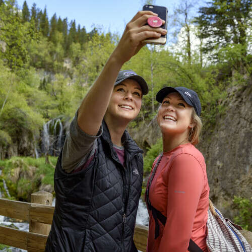 Two visitors taking a selfie in front of Roughlock Falls