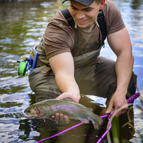 Angler's holding a freshly caught trout