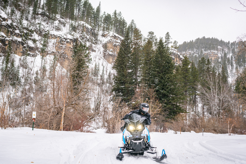 Snowmobile on trail in Spearfish Canyon 