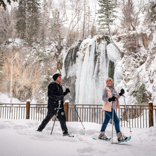 Couple snowshoeing at Spearfish Waterfall 