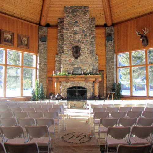 White Wedding Chairs set up inside of the Great Room at Spearfish Canyon Lodge